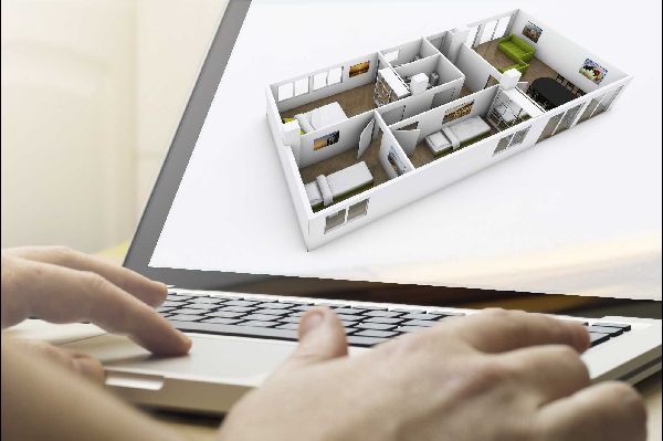 hands typing on the keyboard of a laptop computer with the image of a 3d floor plan on the screen